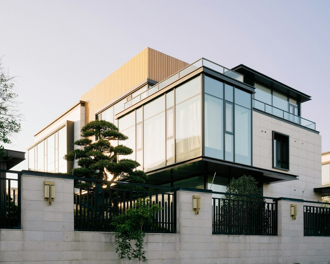 Modernist villa exterior with geometric lines and large glass walls